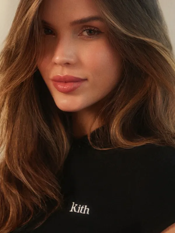 Close beauty portrait of Gabryelle Pedroso wearing a black top in warm light